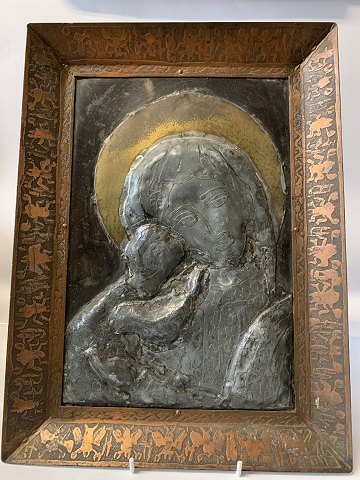Icon of the Virgin Mary with the baby Jesus in a copper frame.
