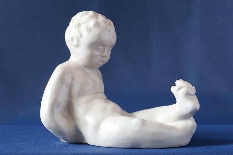 Boy with seeds in earthenware, white with glaze. Michael Andersen.