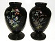 A pair of black glass vases with decorations - both signed