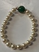 Pearl bracelet in 18 carat gold with beautiful green stone and carabiner clasp.